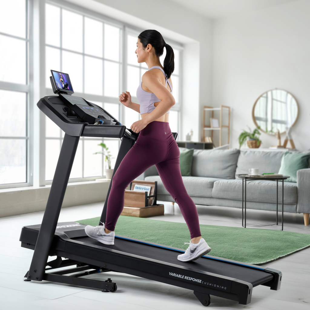 Folding treadmill with thumb-dial controls and hydraulic fold